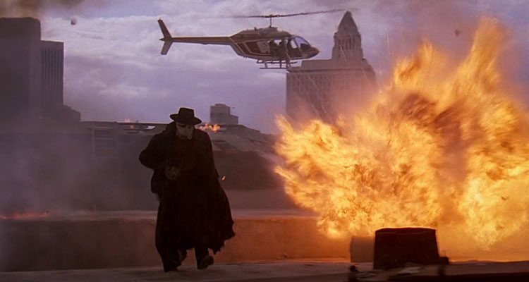 Darkman 1991 Movie Scene Liam Neeson as Peyton Westlake running away from the explosion and helicopter behind him