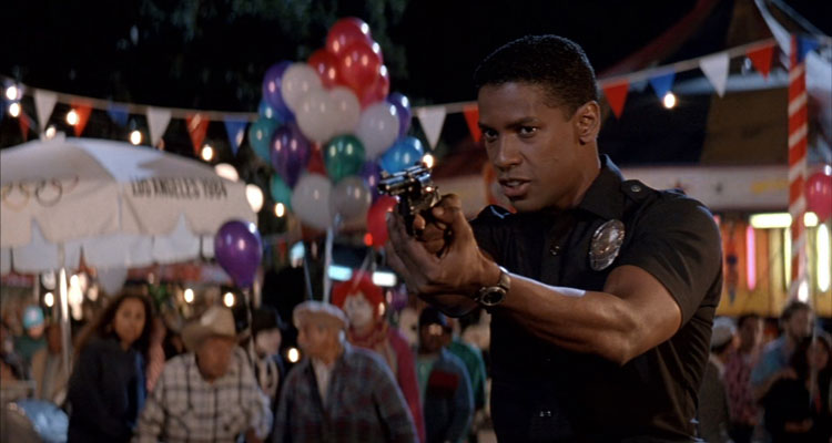 Ricochet 1991 Movie Scene Denzel Washington as Nick Styles holding a gun in a police uniform at the fair