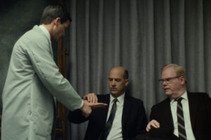 Experimenter 2015 Movie Scene Jim Gaffigan as James McDonough and Anthony Edwards as Miller participating in the experiment