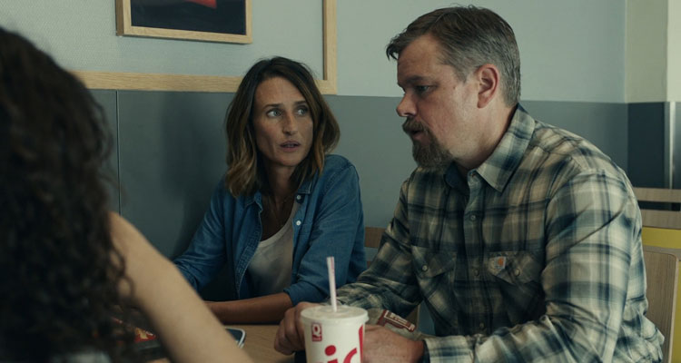 Stillwater 2021 Movie Scene Matt Damon as Bill Baker and Camille Cottin as Virginie talking to two girls in a cafe