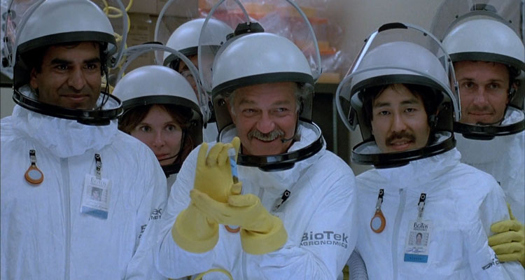 Warning Sign 1985 Movie Scene Richard Dysart as Dr. Nielsen holding a vial and posing for a picture with the rest of the scientist in a laboratory