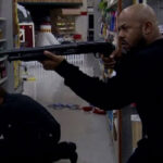 Alien Raiders 2008 Movie Scene Rockmond Dunbar as Kane holding a shotgun inside the supermarket
