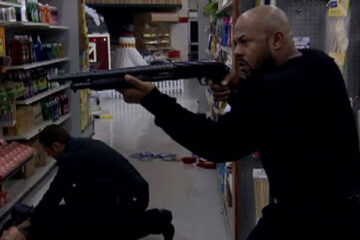 Alien Raiders 2008 Movie Scene Rockmond Dunbar as Kane holding a shotgun inside the supermarket