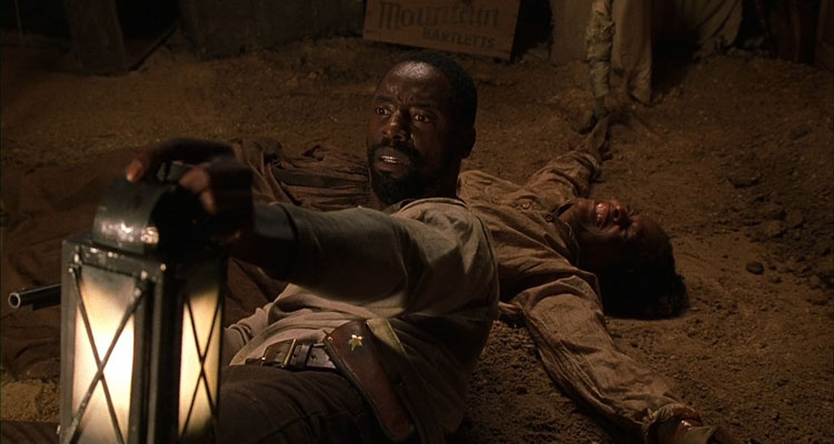 Dead Birds 2004 Movie Scene Isaiah Washington as Todd laying on the ground in the barn and holding a gun
