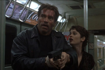 End Of Days 1999 Movie Scene Arnold Schwarzenegger as Jericho and Robin Tunney as Christine holding a gun in subway