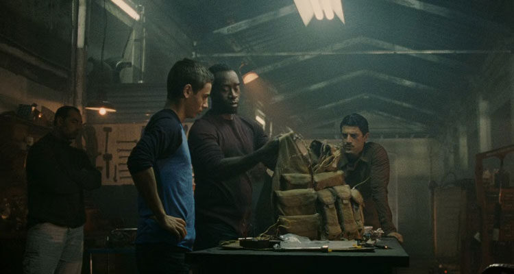 Traitor 2008 Movie Scene Don Cheadle as Samir Horn and Saïd Taghmaoui as Omar giving a young kid a suicide vest
