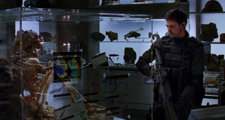 Doom 2005 Movie Scene Karl Urban as John Grimm looking at the skeletal remains in the lab