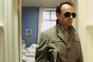 Elling 2001 Movie Scene Per Christian Ellefsen as Elling wearing a trench coat and sunglasses