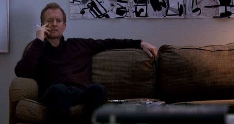 Fear Me Not 2008 Movie Scene Ulrich Thomsen as Mikael smoking a cigarette and thinking about his life