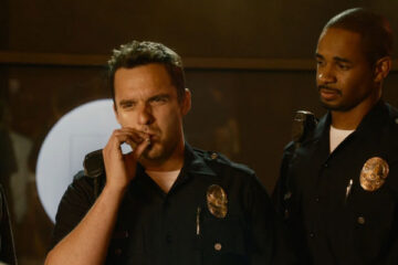 Lets Be Cops 2014 Movie Scene Jake Johnson as Ryan smoking a joint dressed as a cop with Damon Wayans Jr. as Justin looking at him