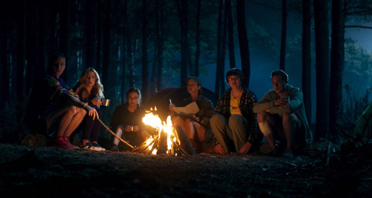Nobody Sleeps in the Woods Tonight 2020 Movie Scene A group from the camp sitting next to a fire during the night
