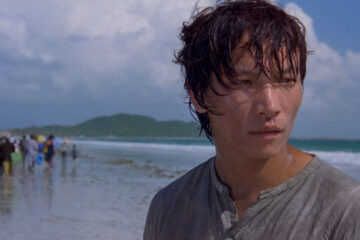 The Beautiful Country 2004 Movie Scene Damien Nguyen as Binh at the beach with the rest of the refugees running in the background