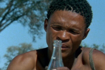 The Gods Must Be Crazy 1980 Movie Scene N!xau as Xi, Bushman looking at the bottle of Coca-Cola that fell out of the sky