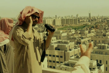 The Kingdom 2007 Movie Scene Two men looking at the city with binoculars