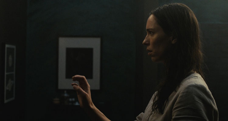 The Night House 2020 Movie Scene Rebecca Hall as Beth in bathroom raising her hand to see if something is there