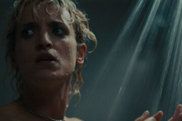 Titane 2021 Movie Scene Agathe Rousselle as Alexia taking a shower when she hears something pounding at the door