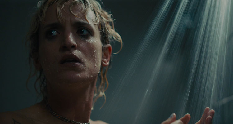 Titane 2021 Movie Scene Agathe Rousselle as Alexia taking a shower when she hears something pounding at the door