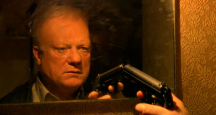 I Stand Alone AKA Seul Contre Tous 1998 Movie Scene Philippe Nahon as The Butcher pointing a gun at himself in the mirror