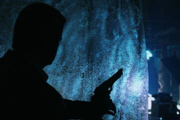 Resurrection 1999 Movie Scene Christopher Lambert as John Prudhomme stumbling through dark holding a gun
