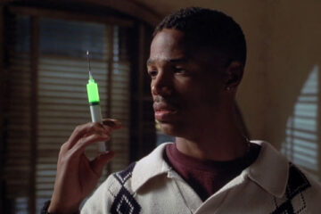 Senseless 1998 Movie Scene Marlon Wayans as Darryl Witherspoon holding an injection with glowing green liquid