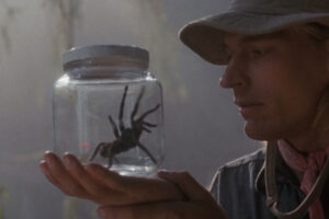 Arachnophobia 1990 Movie Scene Julian Sands as Dr. James Atherton holding a spider trapped inside a jar