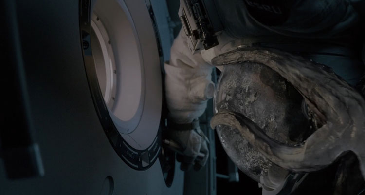Life 2017 Movie Scene An astronaut closing the hatch outside the space station as Calvin, an alien creature with tentacles envelopes it