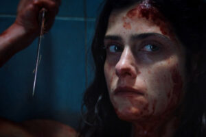 The Advent Calendar AKA Le Calendrier 2021 Movie Scene Eugénie Derouand as Eva covered in blood and holding a knife