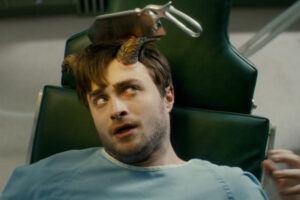 Horns 2013 Movie Scene Daniel Radcliffe as Ig Perrish in a doctors office with a saw stuck in his horn