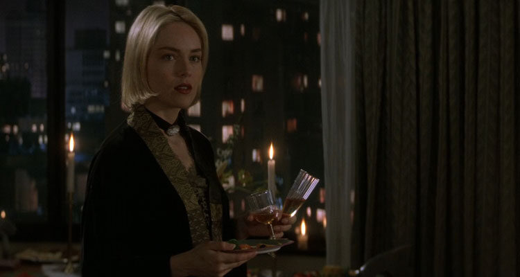 Sliver 1993 Movie Scene Sharon Stone as Carly Norris holding wine glasses at a party