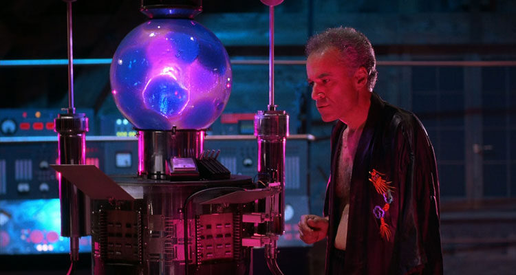 From Beyond 1986 Movie Scene Ted Sorel as Dr. Edward Pretorius nest to The Resonator as it's working