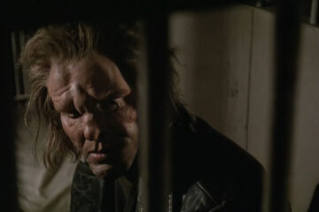 Johnny Handsome 1989 Movie Scene Mickey Rourke as Johnny Handsome, a criminal with a disfigured face siting in a prison cell