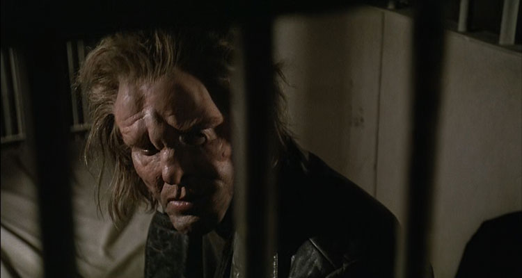 Johnny Handsome 1989 Movie Scene Mickey Rourke as Johnny Handsome, a criminal with a disfigured face siting in a prison cell
