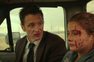 Small Town Crime 2017 Movie Scene John Hawkes as Mike and Stefanie Scott as Ivy covered in blood after a chase