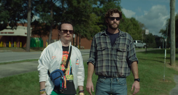 Arkansas 2020 Movie Scene Liam Hemsworth as Kyle and Clark Duke as Swin watching police snoop around their truck
