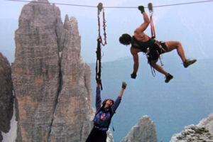 Cliffhanger 1993 Movie Scene Sylvester Stallone as Gabe Walker extending his hand to woman hanging on to her life