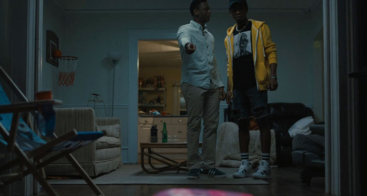 Emergency 2022 Movie Scene RJ Cyler as Sean and Donald Elise Watkins as Kunle finding a passed out girl in their home