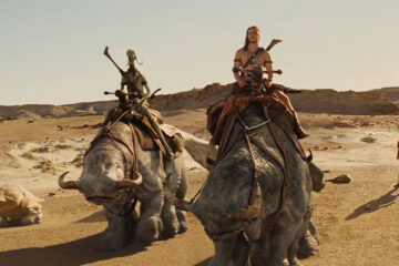 John Carter 2012 Movie Scene Taylor Kitsch as John Carter riding a strange creature on Mars