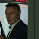 Memory 2022 Movie Scene Liam Neeson as Alex Lewis holding a gun with a silencer