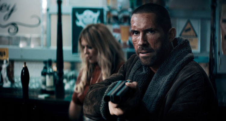 Avengement 2019 Movie Scene Scott Adkins as Cain Burgess holding a double-barreled shotgun in a bar