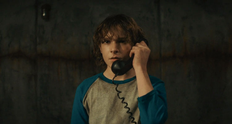 The Black Phone Movie 2021 Scene Mason Thames as Finney talking over the phone in the basement