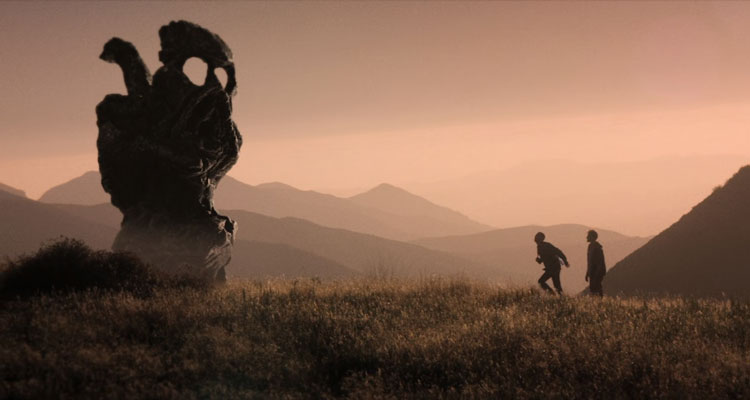 The Endless Movie 2017 Scene Aaron Moorhead as Aaron and Justin Benson as Justin walking by a huge Cthulhu statue