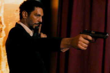 Sleepless Night AKA Nuit Blanche Movie 2011 Scene Tomer Sisley as Vincent holding a gun in a nightclub