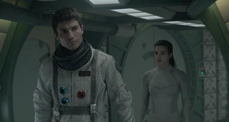 Orbiter 9 2017 Movie Scene Álex González as Álex in a spacesuit and Clara Lago as Helena inside the spaceship