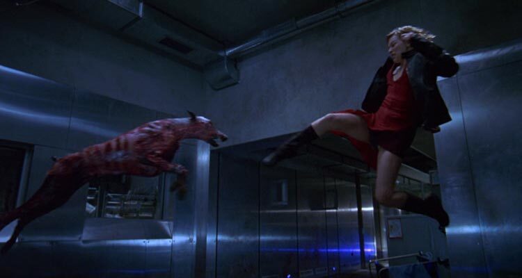Resident Evil 2002 Movie Scene Milla Jovovich as Alice kicking the zombie dog in the air