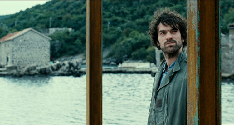 The Big Picture 2010 Movie Scene Romain Duris as Paul Exben at the dock in a small coastal town in Montenegro