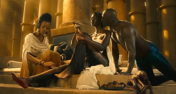 Three Thousand Years of Longing 2022 Movie Scene Idris Elba as The Djinn talking to Aamito Lagum as The Queen of Sheba shaving her legs