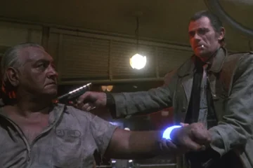 Trancers 1984 Movie Scene Tim Thomerson as Jack Deth holding a laser pistol to a suspected trancer