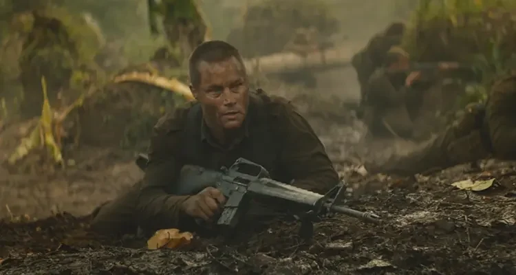 Danger Close The Battle of Long Tan 2019 Movie Scene Travis Fimmel as Major Harry Smith holding an M-16 rifle in the woods