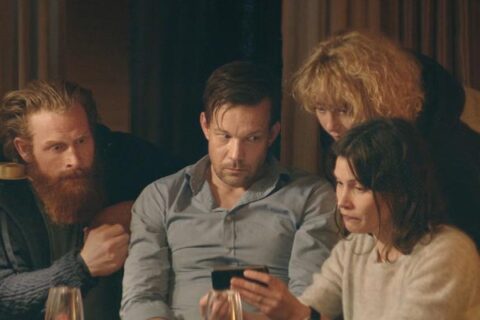 Force Majeure 2014 Movie Scene Johannes Kuhnke as Tomas, Lisa Loven Kongsli as Ebba, Fanni Metelius as Fanny and Kristofer Hivju as Mats looking at a video of Tomas running away from an avalanche