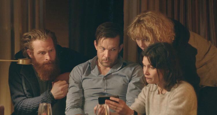 Force Majeure 2014 Movie Scene Johannes Kuhnke as Tomas, Lisa Loven Kongsli as Ebba, Fanni Metelius as Fanny and Kristofer Hivju as Mats looking at a video of Tomas running away from an avalanche